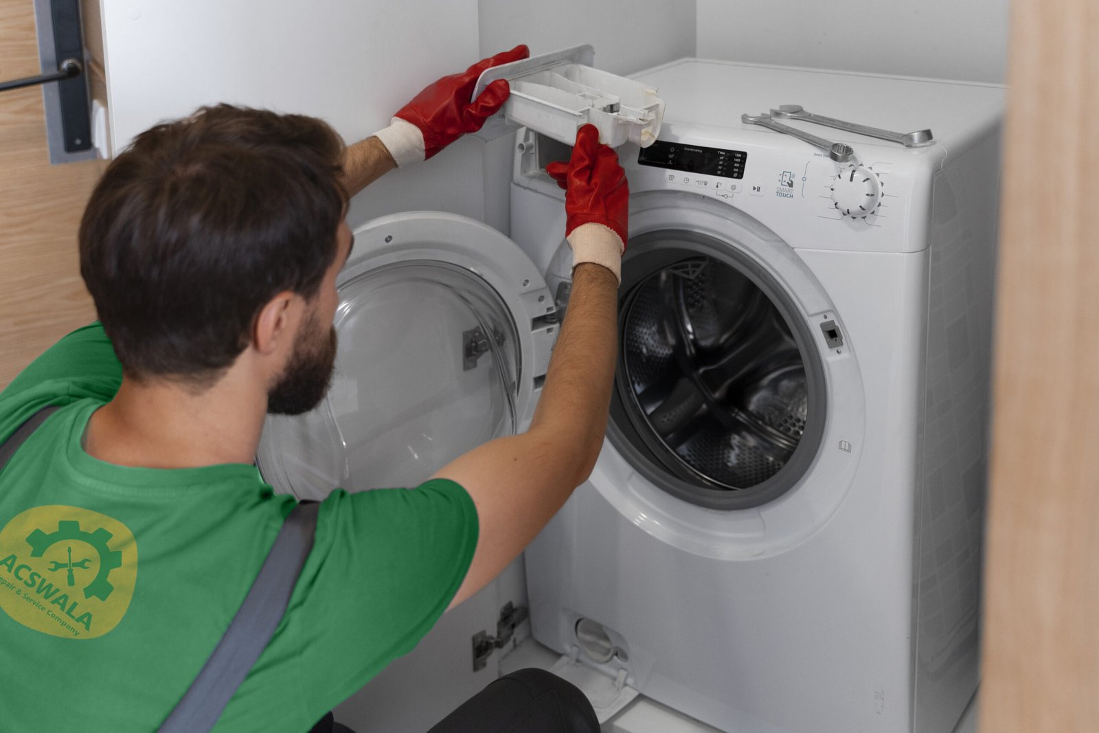 A man in a green shirt repairing a refrigerator. Find washing machine repair near me
